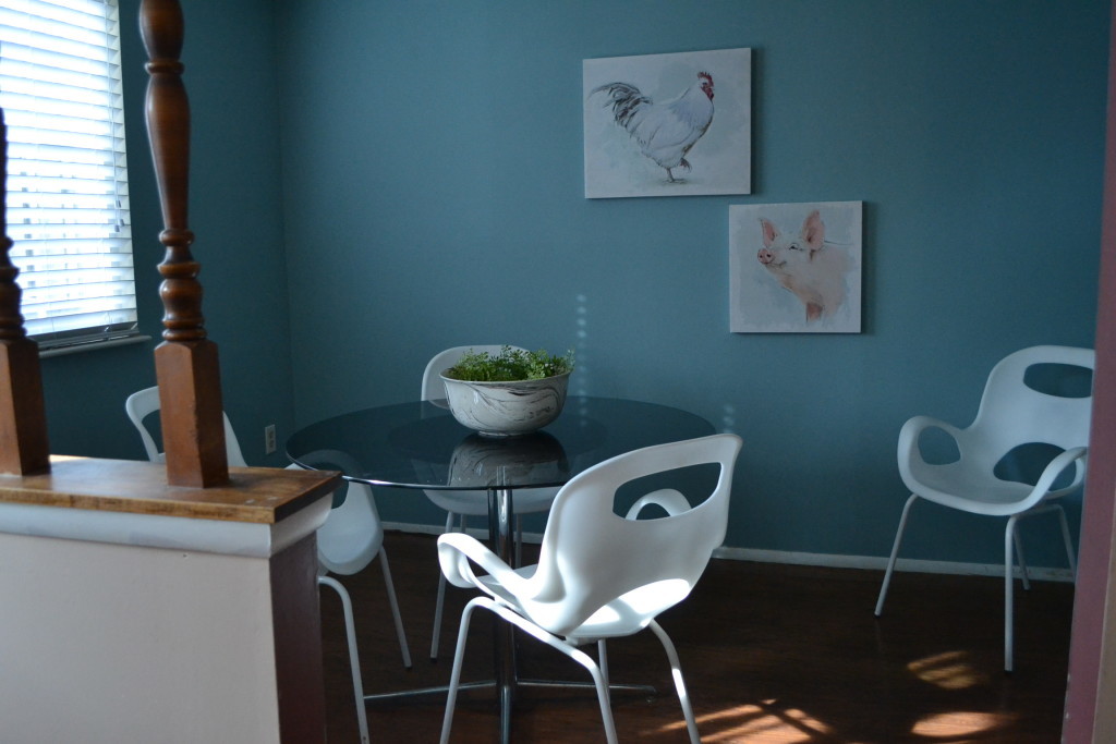 The dining room, enlivened with playful art and clean, modern furnishings (as seen from the study).