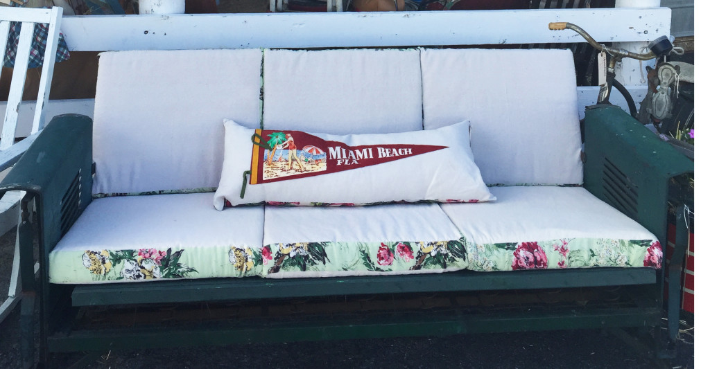 All-American glider. If you've never experienced a vintage porch glider, you haven't lived! Few things are as perfect a locale for a warm summer evening's drink with friends. This comfortable cotton upholstery, with the vintage fabric trim is spot-on perfect.