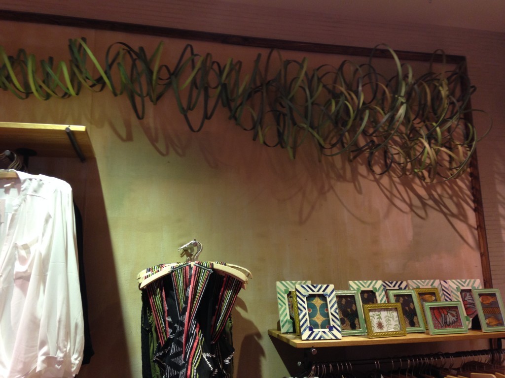 The thin wood curls over this clothing display are really draws your eye up.