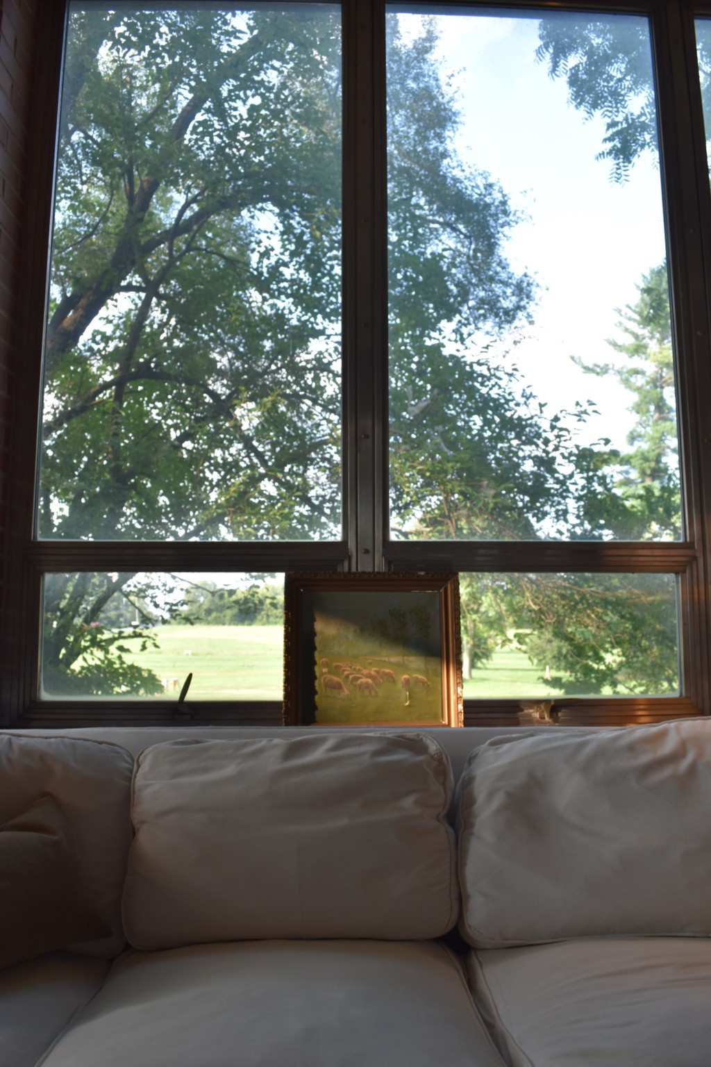 steel windows, slipcovered sofa, vintage art