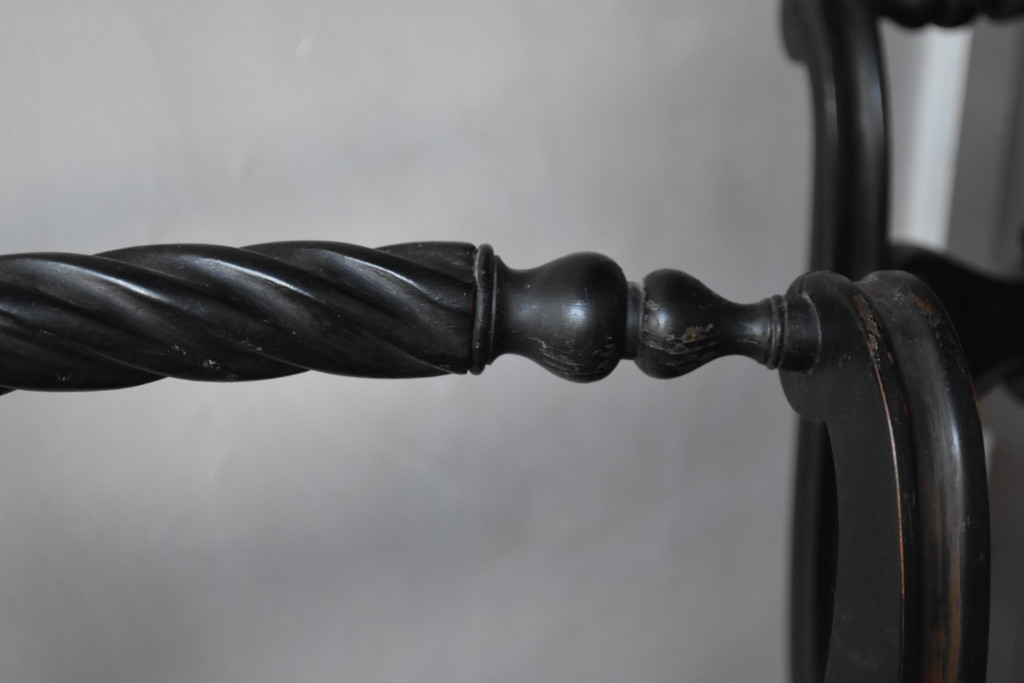 The top, back of each chair is this beautifully carved, sideways spindle. 